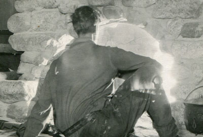 Frank at fireplace in Wa-wan cabin